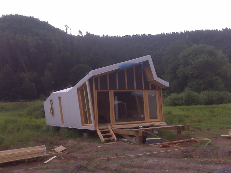 a large white tiny house with wooden steps