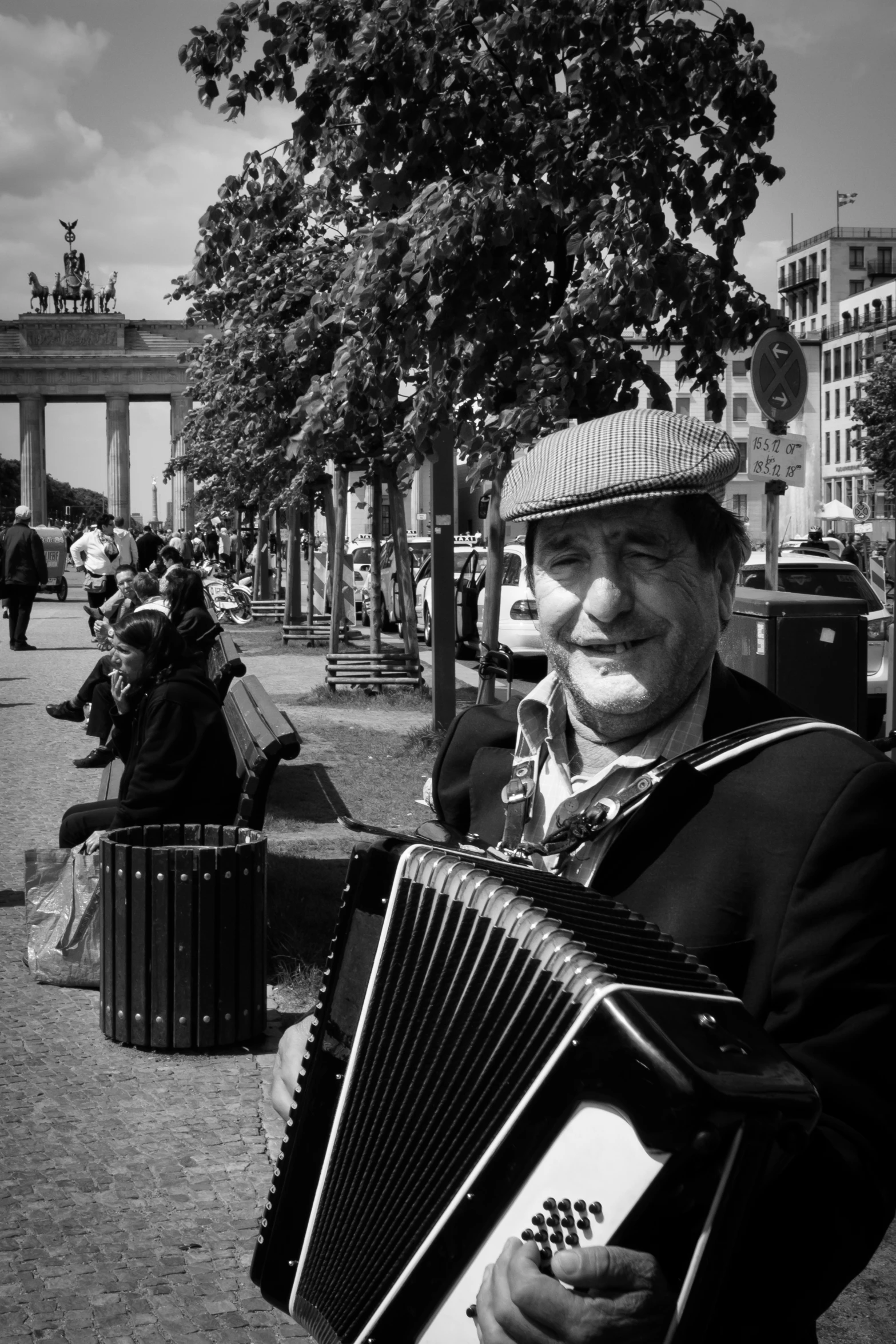 a man standing holding an accordion in his hand