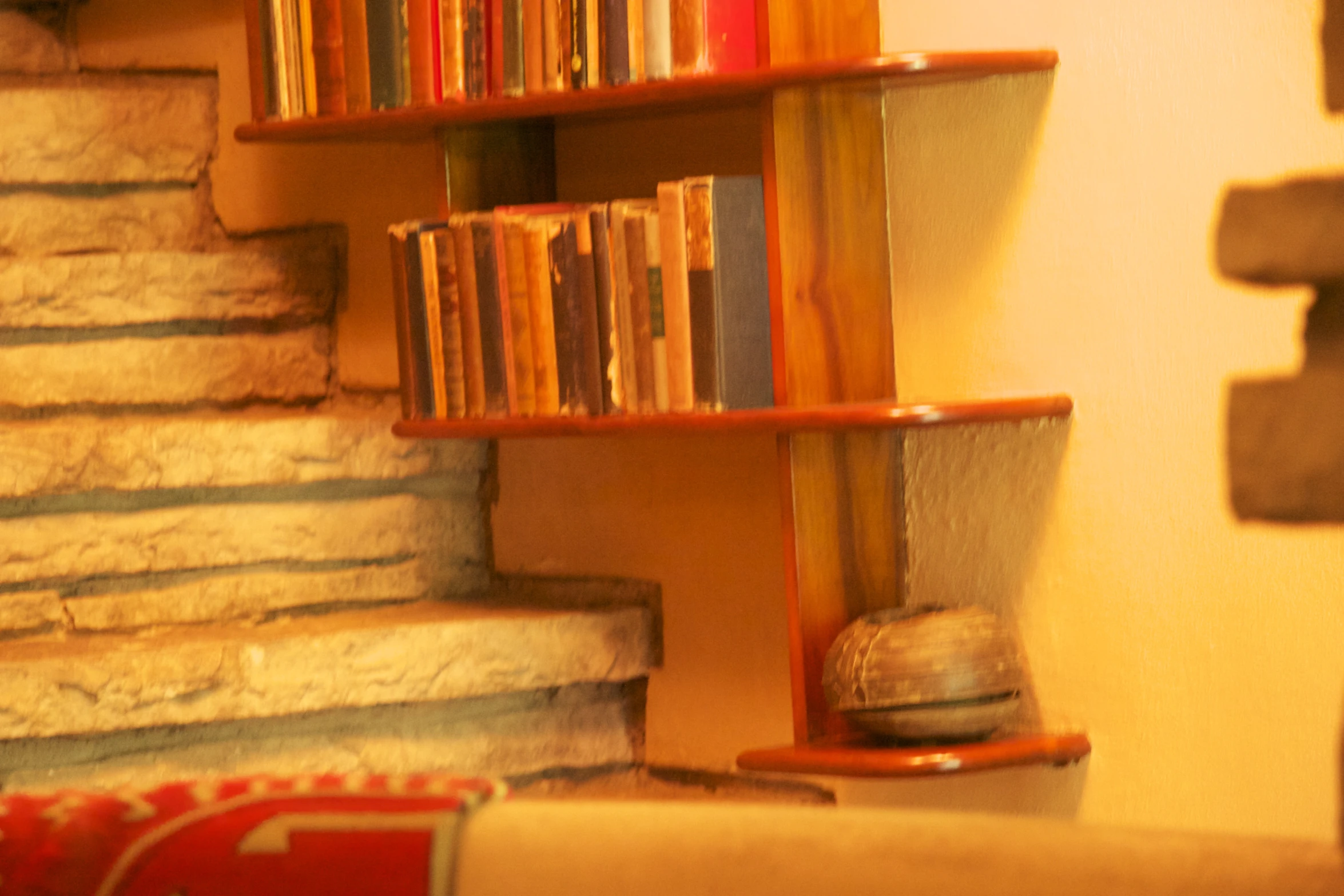 some books a fireplace and some stairs