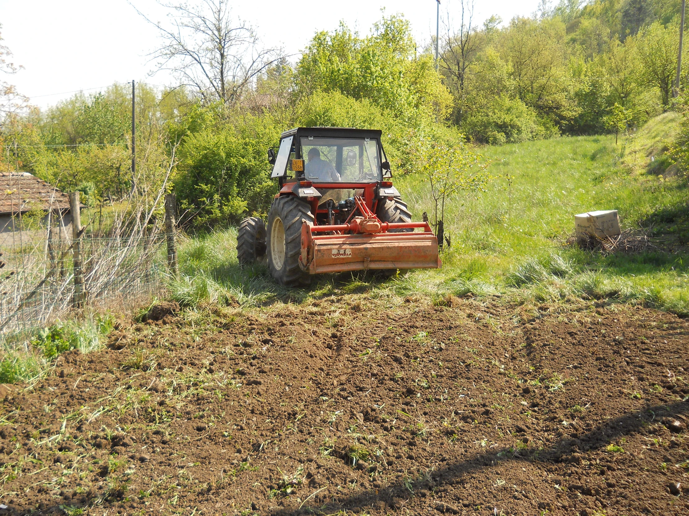 a large engine mower on the side of a dirt road