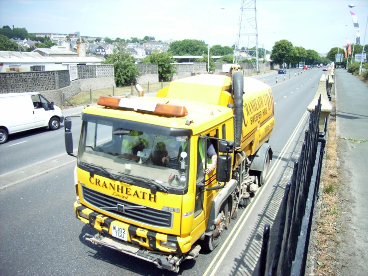 a cement truck that is pulling another truck down the road