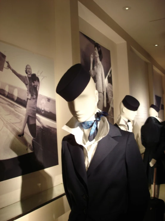 the mannequins are wearing suits and hats