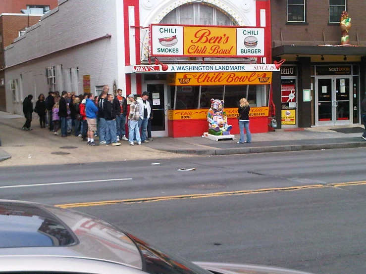 the crowd is waiting outside a business for customers