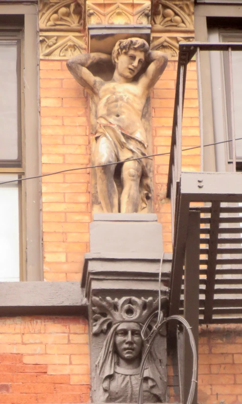 the statue has been placed in front of the brick building