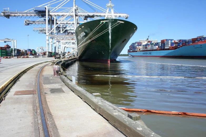 a cargo ship being unloaded at a dock