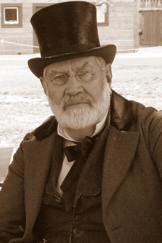 an old po of a man with a top hat and glasses