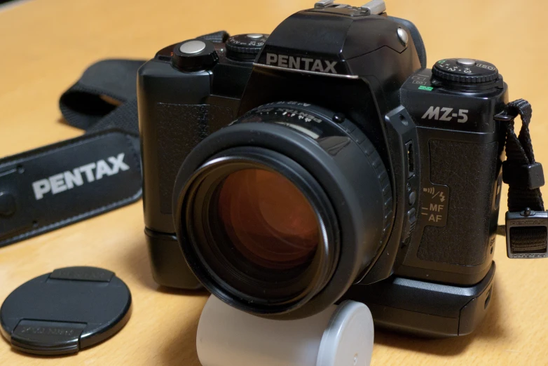 an expensive camera set up on top of a wooden table