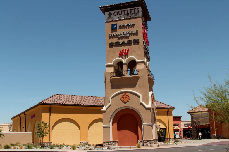 the front of a store with a clock tower in the middle