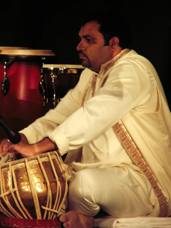 a man with drums in front of his