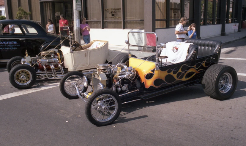 a buggy parked in a street filled with cars