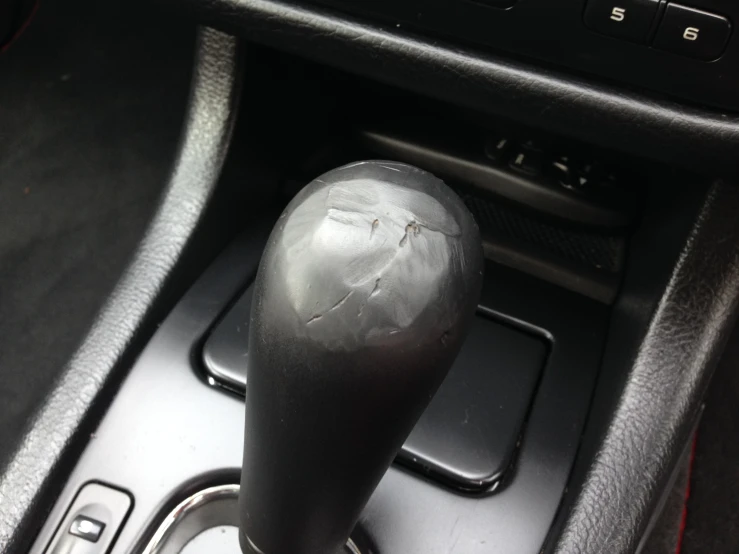 an automatic gear lever with a ed white piece of paper on it