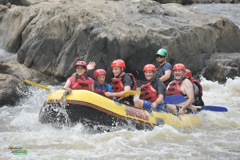 a group of people white water rafting through rapids