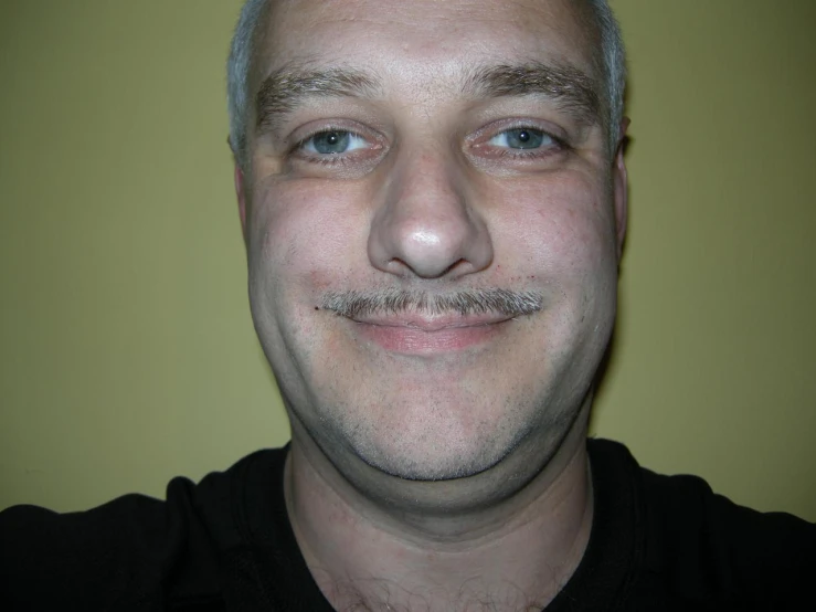 a man with a fake mustache smiling