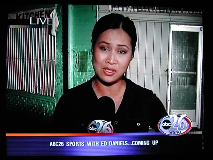 a woman is shown on the news screen talking