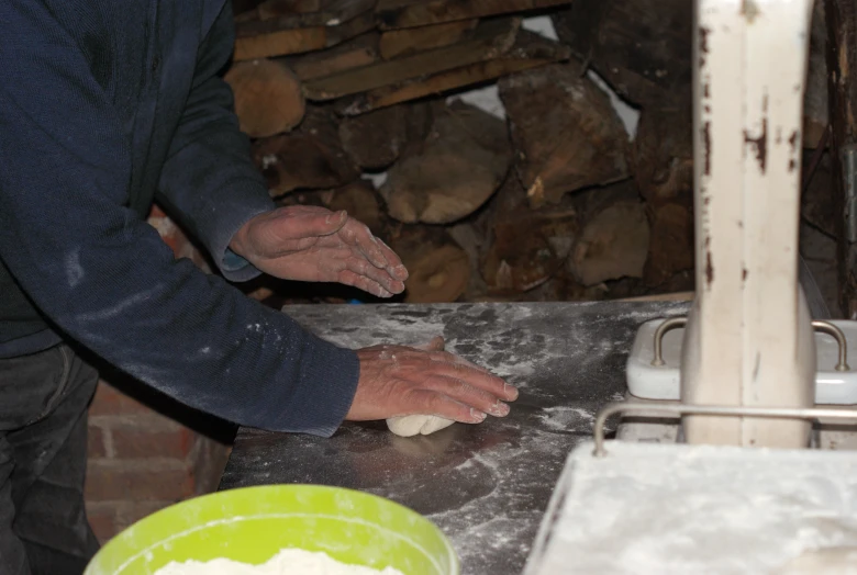 someone is preparing dough on the counter in their home