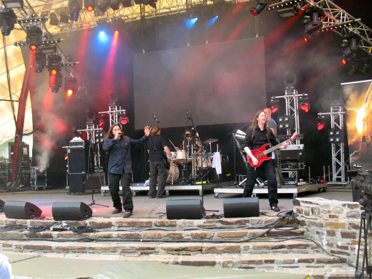 a band playing on stage during a music festival