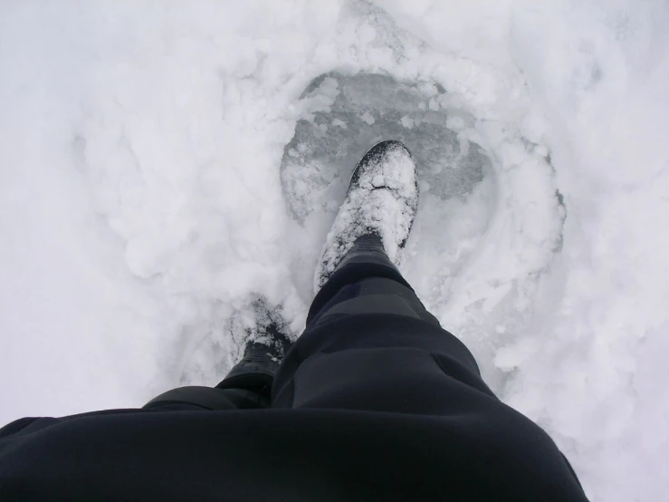 a skier is walking along the snow and ice