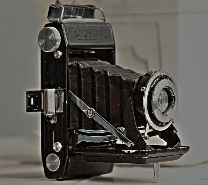 an old fashioned camera on display against a wall