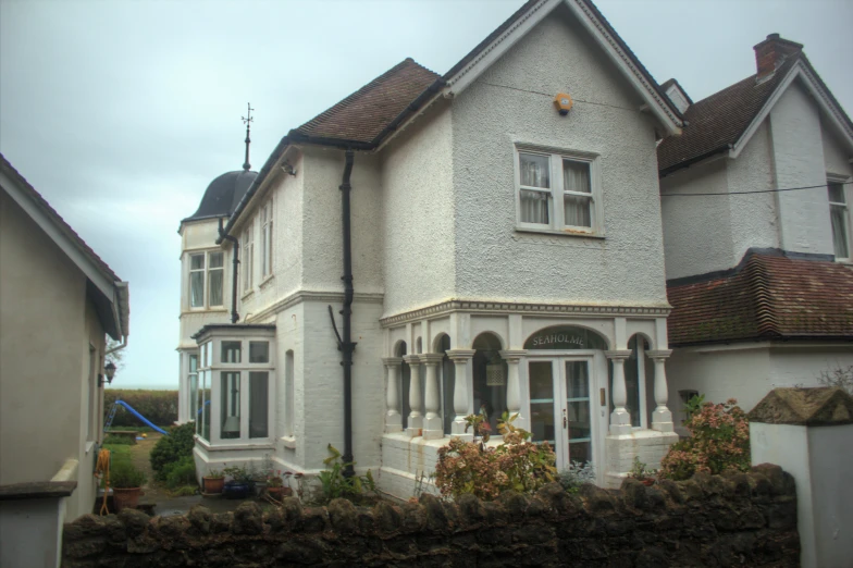 the house has several windows and a fence around it