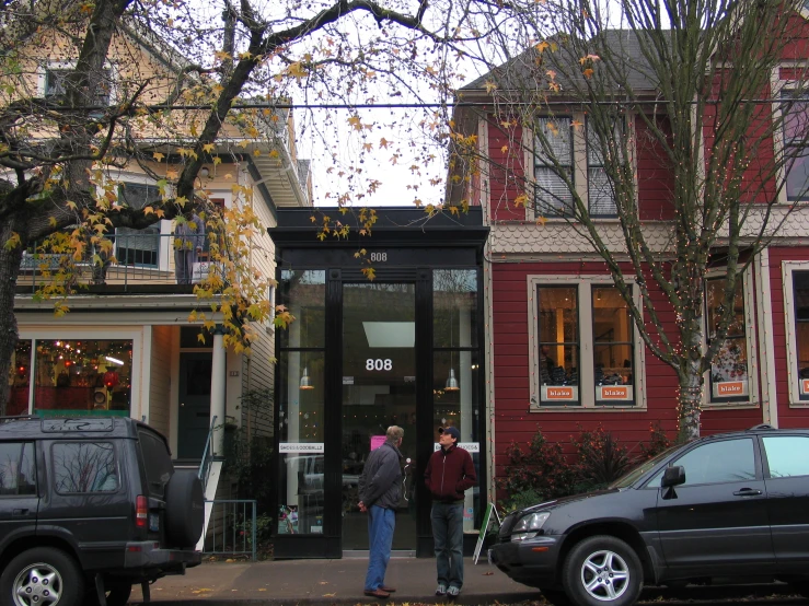 people in front of an upscale residential area with a glass entrance to a barbershop