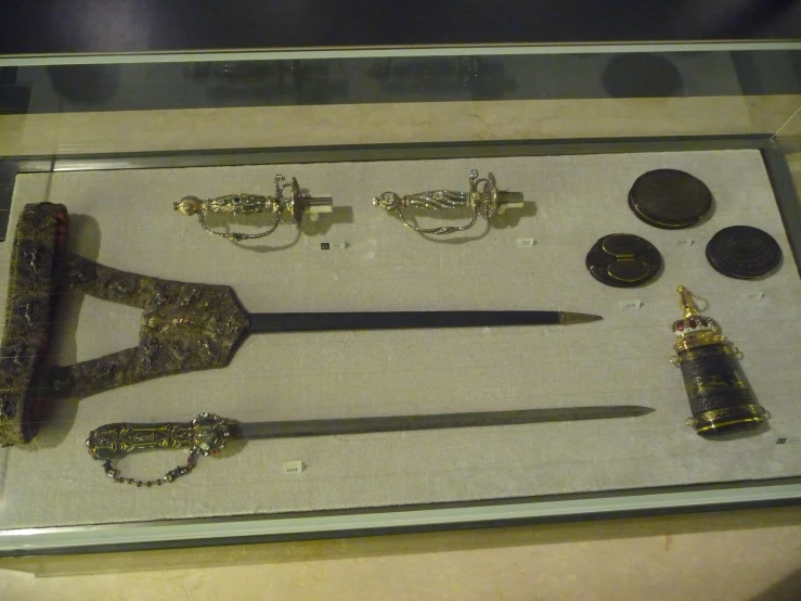 an elaborate display case filled with gold and different types of metal items