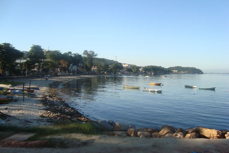 a beach that is next to some rocks and water