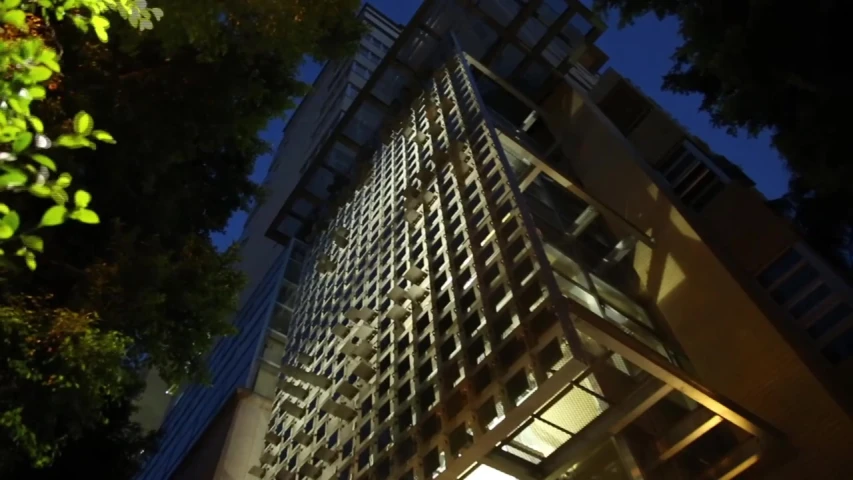 building with metal and glass sides next to trees