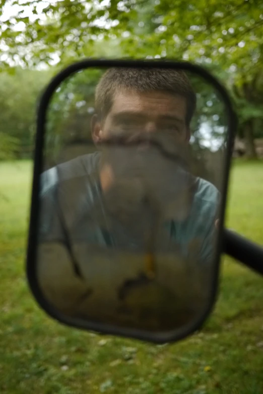 a man in a blue shirt is looking at the camera