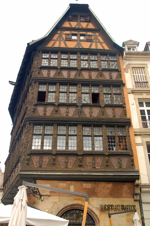 a tall building with brown walls, windows and ornate decorations