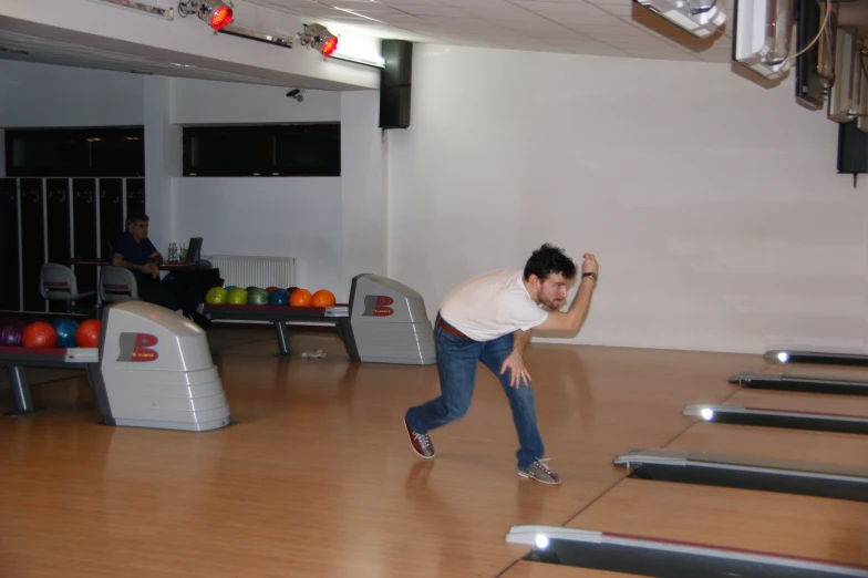 a man plays bowling at a bowling alley