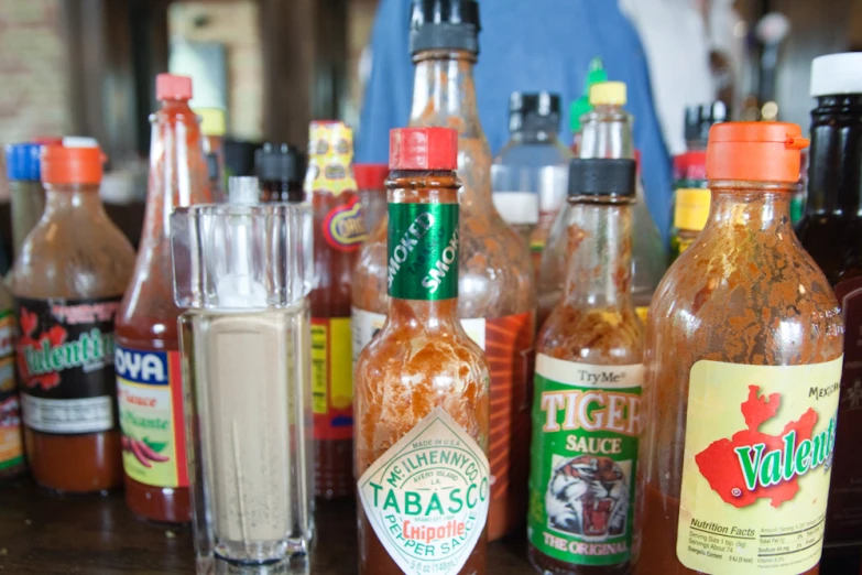 an assortment of  sauces and other condiments sit on a table