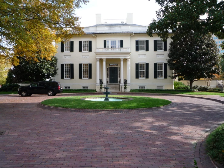 the house has large windows and is situated on the green lawn