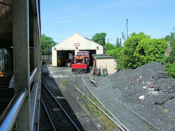 there is a small train that is on the tracks