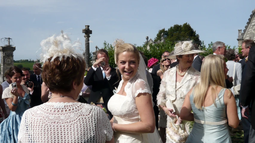 two woman at a wedding talking to each other