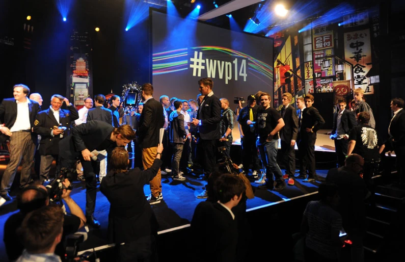 a big crowd of people on stage with a band on the side of it