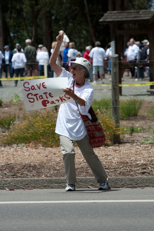 a man standing on the road holding a sign