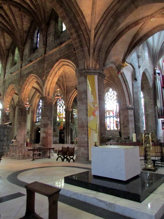 an old church with pews and vaulted ceiling