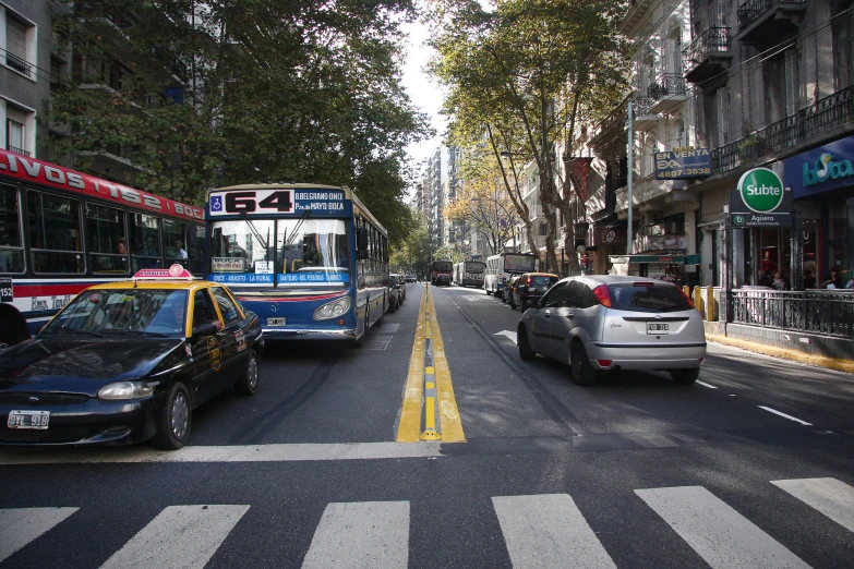 a city street filled with traffic next to buildings