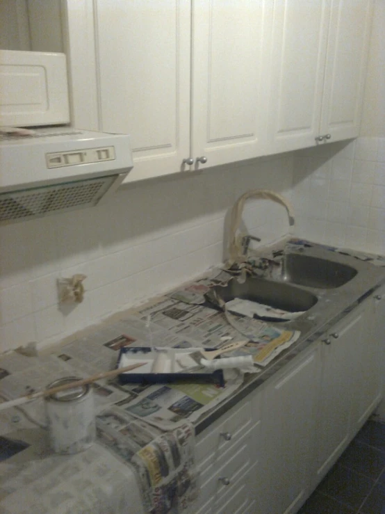 newspapers lay on the counter tops of a kitchen