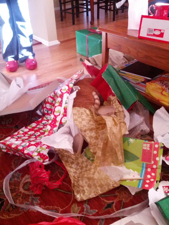 presents and paper bags lie on the floor