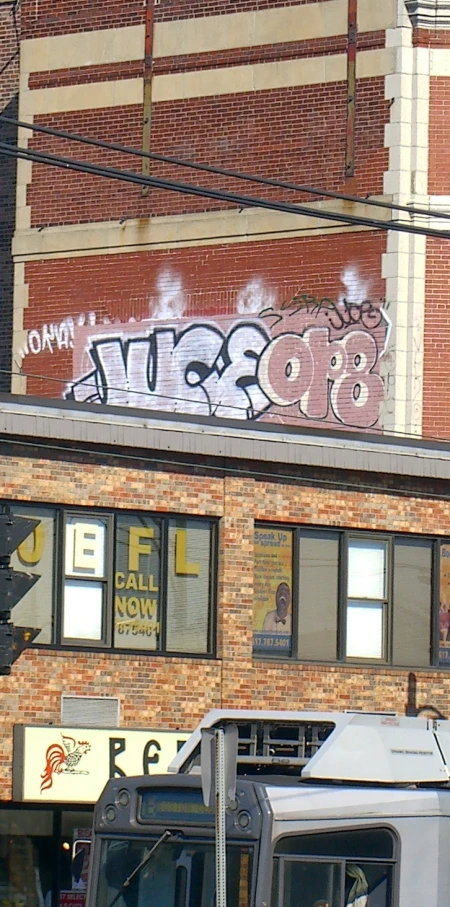 an old fashioned truck sits parked outside a building