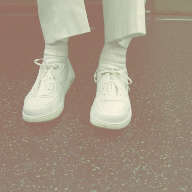 a person standing in front of the camera with a pair of shoes on