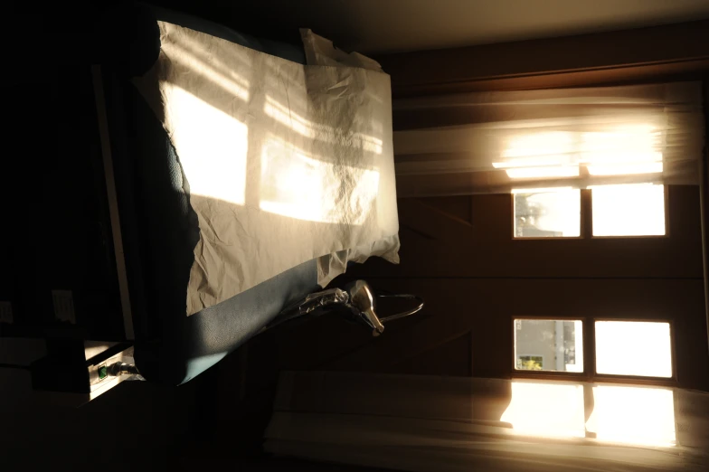 the bedroom has the sun coming in through the windows