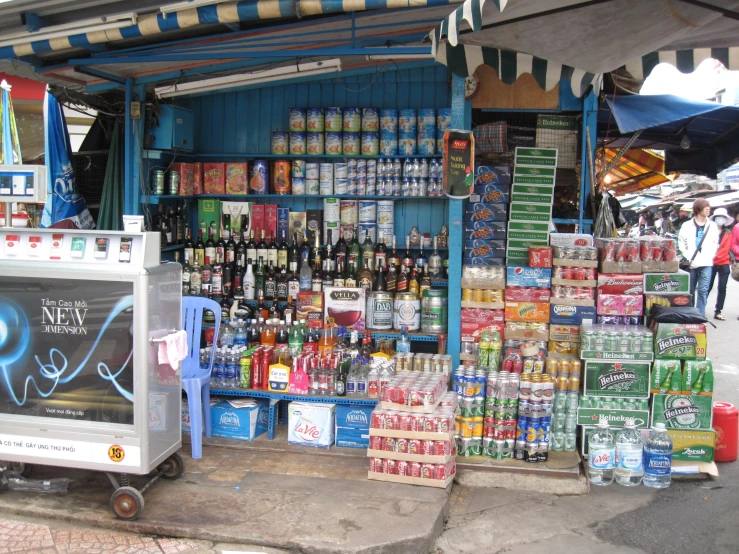 a street vendor selling beer, beverages, and water