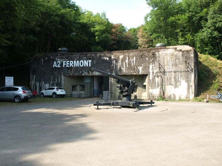 a large brown building with an old cement sign