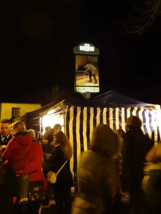 many people are looking at the lights at an outside event