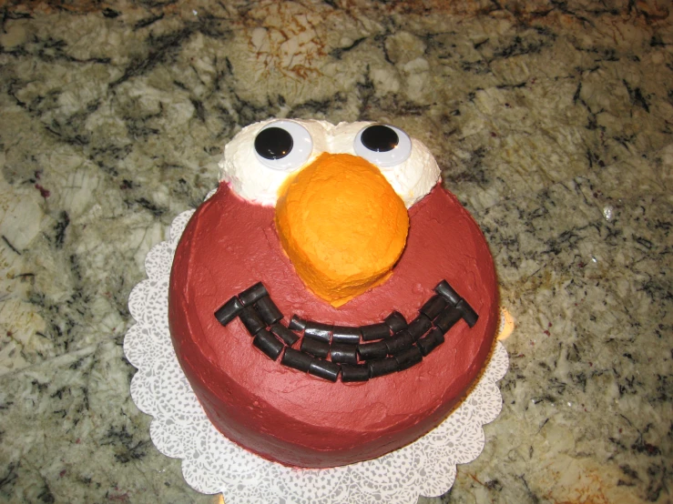 a red cake with an angry bird face on it