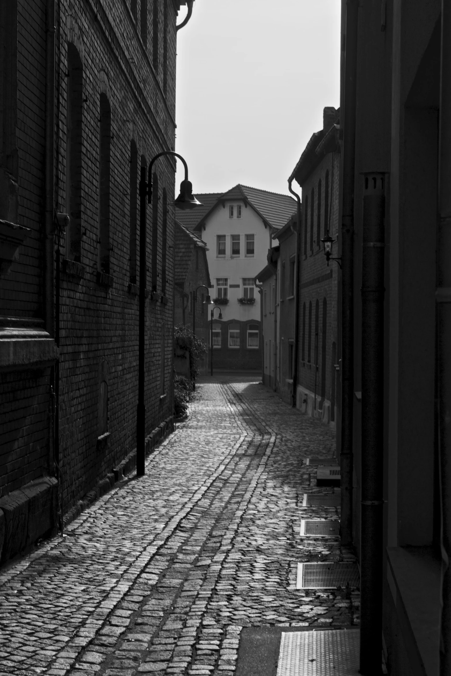 a street is shown with the sidewalk and buildings