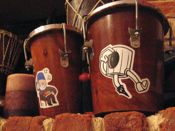 there are different drums that look like they have stickers on them