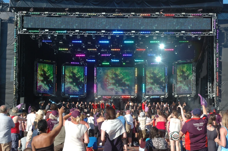 a group of people standing around a stage